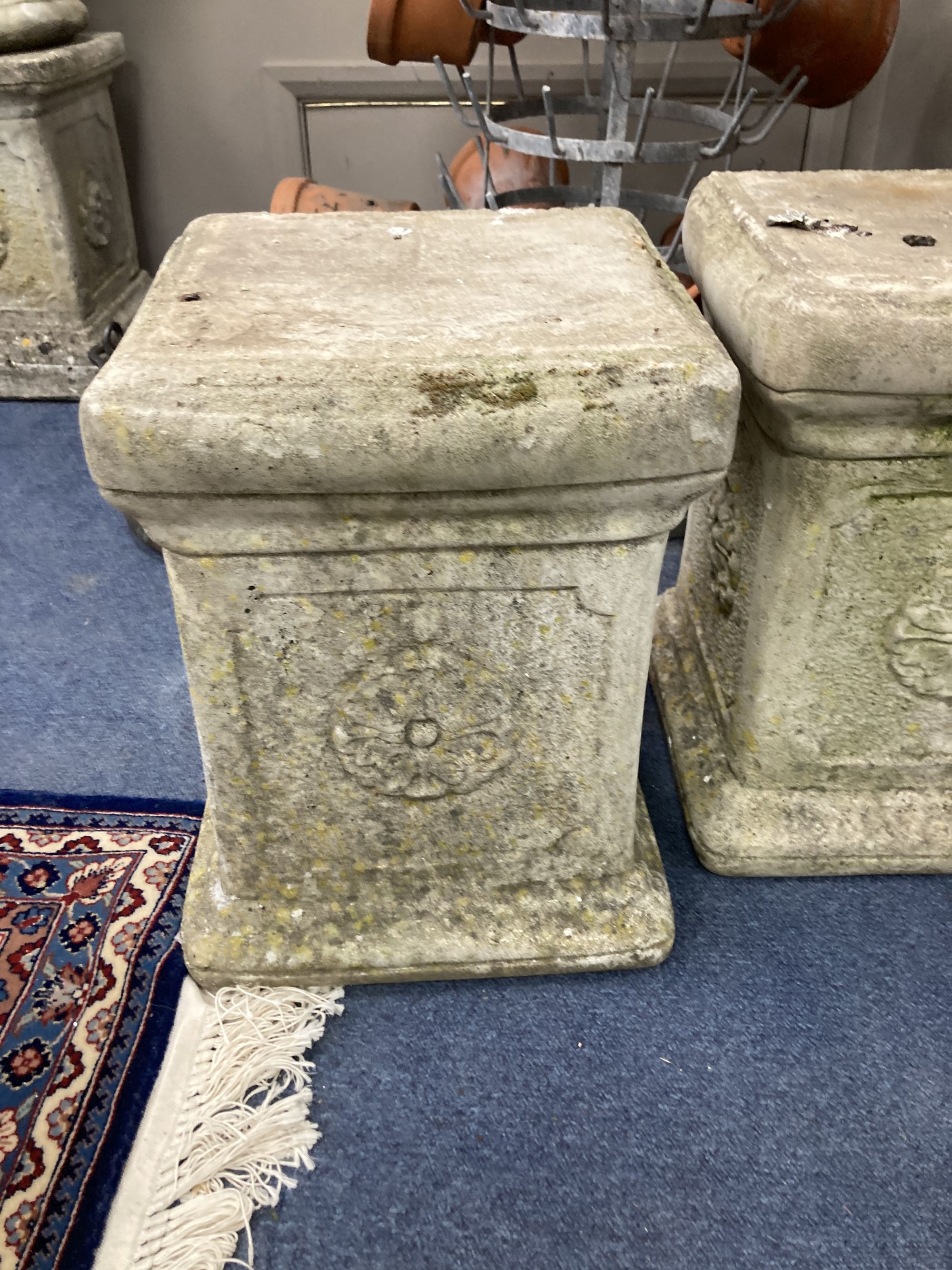 A pair of reconstituted stone plinths, height 39cm